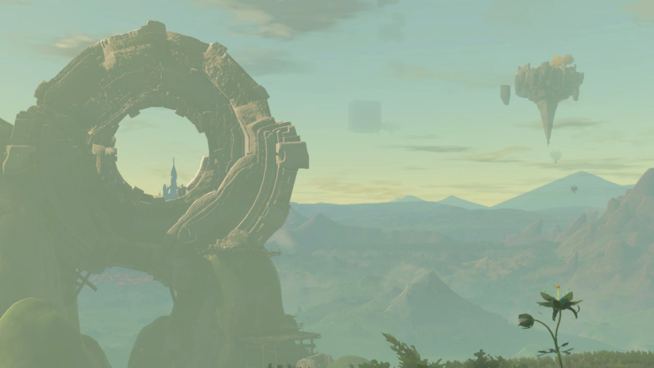 A photo taken from above Kakariko Village facing Hyrule Castle. A Ring Ruin resting on a stone arch with scaffolding encircles the castle's gloomy sillhoutte. A Silent Princess blooms in the grass in the bottom-right of the image