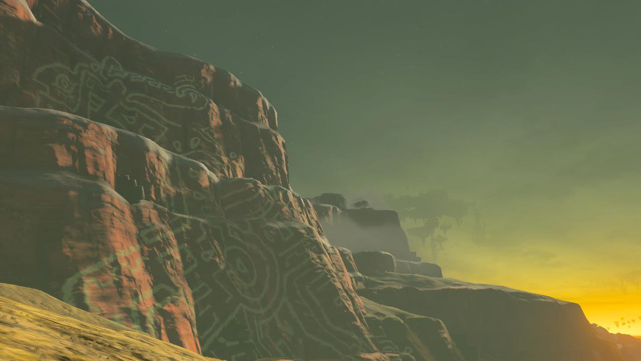 The geoglyph's lines rest as if projected on the red face of the cliff by the sunrise lighting it